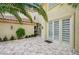 Charming outdoor patio features decorative tiled flooring, elegant architectural details, and lush landscaping for private outdoor relaxation at 8051 Castle Pines Ave, Las Vegas, NV 89113