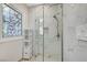 Modern shower design with unique stained glass window bringing light into the space at 8051 Castle Pines Ave, Las Vegas, NV 89113