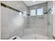 Luxurious walk-in shower with rain shower head and elegant marble tiling at 8051 Castle Pines Ave, Las Vegas, NV 89113