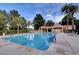 Large, sparkling swimming pool with clear blue water, surrounded by lounge chairs and lush landscaping for ultimate relaxation at 8051 Castle Pines Ave, Las Vegas, NV 89113