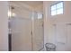 Bathroom features a glass enclosed shower with white tile and modern fixtures and window at 8171 California Pine St, Las Vegas, NV 89166