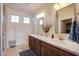 Bright bathroom featuring double sinks, white counters and modern fixtures and window at 8171 California Pine St, Las Vegas, NV 89166