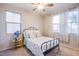 Bright bedroom featuring natural light, a ceiling fan, and neutral carpeting at 8171 California Pine St, Las Vegas, NV 89166