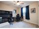 Bedroom featuring a spacious layout, ceiling fan, natural light, and a dark wood desk at 8171 California Pine St, Las Vegas, NV 89166