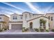 Beautiful two-story home with a neutral color scheme, arched entry, and attached two-car garage at 8171 California Pine St, Las Vegas, NV 89166