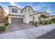 Charming home featuring a brick driveway, attached garage, stucco finish, and manicured landscaping at 8171 California Pine St, Las Vegas, NV 89166