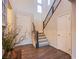 Inviting foyer with wood floors, a staircase with decorative railing, and plenty of natural light at 8171 California Pine St, Las Vegas, NV 89166