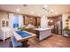 Modern kitchen with stainless steel appliances, shaker cabinets, a center island, and wood floors at 8171 California Pine St, Las Vegas, NV 89166