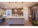 Modern kitchen with stainless steel appliances, shaker cabinets, a center island, and wood floors at 8171 California Pine St, Las Vegas, NV 89166