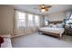 Bright main bedroom features multiple windows, natural light and modern ceiling fan at 8171 California Pine St, Las Vegas, NV 89166
