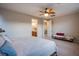 Spacious main bedroom featuring a neutral color palette, ceiling fan and ensuite bathroom at 8171 California Pine St, Las Vegas, NV 89166