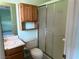 The bathroom features a vanity with upper cabinet, toilet and shower at 881 E Calvada Blvd, Pahrump, NV 89048