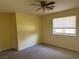 A spacious bedroom features neutral carpet and window for natural light at 881 E Calvada Blvd, Pahrump, NV 89048