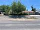 Charming single-story home featuring a tile roof, well-maintained landscaping, and an attached two car garage at 881 E Calvada Blvd, Pahrump, NV 89048