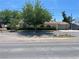 Charming single-story home featuring a tile roof, well-maintained landscaping, and an attached two car garage at 881 E Calvada Blvd, Pahrump, NV 89048