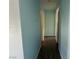Hallway with light blue walls and wood look flooring at 881 E Calvada Blvd, Pahrump, NV 89048