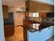 Features of this kitchen include wood cabinets and black countertops at 881 E Calvada Blvd, Pahrump, NV 89048