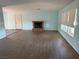 Spacious living room with wood floors, fireplace, and bright windows at 881 E Calvada Blvd, Pahrump, NV 89048