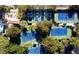 Aerial view of well-maintained tennis courts surrounded by trees, next to the pool at 8969 Rivers Edge Dr, Las Vegas, NV 89117