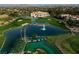 Stunning aerial view showcasing a luxurious home with lush golf course and water features at 8969 Rivers Edge Dr, Las Vegas, NV 89117