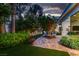 Charming backyard patio with outdoor seating, lush plantings and serene water feature at 8969 Rivers Edge Dr, Las Vegas, NV 89117
