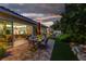 Inviting backyard patio featuring a dining area, lush landscaping, and seamless indoor-outdoor flow at 8969 Rivers Edge Dr, Las Vegas, NV 89117
