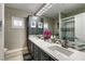 Modern bathroom featuring dual sinks, sleek countertops, and a glass-enclosed shower at 8969 Rivers Edge Dr, Las Vegas, NV 89117