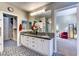 Bathroom with double sinks, patterned tile flooring, and access to the walk-in closet at 8969 Rivers Edge Dr, Las Vegas, NV 89117