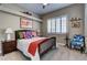 Charming bedroom featuring a decorative bed, plush carpet, and a bright window with shutters at 8969 Rivers Edge Dr, Las Vegas, NV 89117