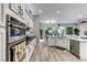 Updated kitchen with modern appliances, white cabinets, and views into the back yard at 8969 Rivers Edge Dr, Las Vegas, NV 89117