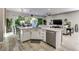 Kitchen island with stainless steel dishwasher, white cabinets, and a view of the backyard at 8969 Rivers Edge Dr, Las Vegas, NV 89117