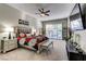 Comfortable main bedroom suite with a ceiling fan, sliding glass doors, and neutral decor at 8969 Rivers Edge Dr, Las Vegas, NV 89117