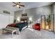 Spacious main bedroom suite with an accent chair, a ceiling fan, and carpet flooring at 8969 Rivers Edge Dr, Las Vegas, NV 89117