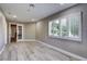 Inviting room featuring hardwood floors, neutral walls, and a bright window with shutters at 8969 Rivers Edge Dr, Las Vegas, NV 89117