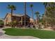 Beautiful backyard with pool, lawn, and palm trees; perfect for outdoor entertaining at 9012 Alpine Peaks Ave, Las Vegas, NV 89147