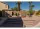 Paver patio with a fire pit, seating, shed, and landscaping at 9012 Alpine Peaks Ave, Las Vegas, NV 89147