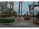 Backyard with a pool, spiral staircase, outdoor seating, and mature landscaping at 9012 Alpine Peaks Ave, Las Vegas, NV 89147