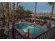 Aerial view of a backyard with a pool, lounge chairs, a trampoline, and patio furniture at 9012 Alpine Peaks Ave, Las Vegas, NV 89147