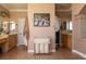 Bathroom featuring double sinks, granite countertops, and a laundry hamper for convenience and organization at 9012 Alpine Peaks Ave, Las Vegas, NV 89147