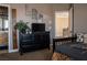 Bedroom featuring gray walls, a large dresser with a TV, and an ensuite bathroom at 9012 Alpine Peaks Ave, Las Vegas, NV 89147
