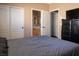 Bedroom with carpet, closet doors, and a bathroom through an open doorway at 9012 Alpine Peaks Ave, Las Vegas, NV 89147