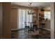 Dining area with tile floors, modern chandelier, shutters, and backyard view at 9012 Alpine Peaks Ave, Las Vegas, NV 89147