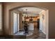 View of the dining area and modern kitchen, seamlessly connected through an arched doorway at 9012 Alpine Peaks Ave, Las Vegas, NV 89147