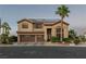Two-story home with a three-car garage, desert landscaping, and solar panels at 9012 Alpine Peaks Ave, Las Vegas, NV 89147