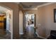 Inviting hallway with decorative tile flooring, arched doorways, and views of the living spaces at 9012 Alpine Peaks Ave, Las Vegas, NV 89147