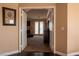A living room viewed from the hallway with a fireplace, french doors, and carpet at 9012 Alpine Peaks Ave, Las Vegas, NV 89147