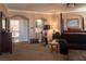 Large primary suite with carpet, accent lighting, fireplace, exercise bike, and lounge area at 9012 Alpine Peaks Ave, Las Vegas, NV 89147