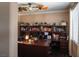 Comfortable office space featuring a ceiling fan, large desk, and built-in bookshelves for organized storage at 9012 Alpine Peaks Ave, Las Vegas, NV 89147