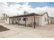 A welcoming backyard with a covered patio, concrete flooring, a swing, and a convenient access door at 902 Westminster Ave, Las Vegas, NV 89119