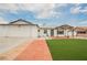 The home has a well-manicured front lawn, brick-paved driveway, and attached garage at 902 Westminster Ave, Las Vegas, NV 89119